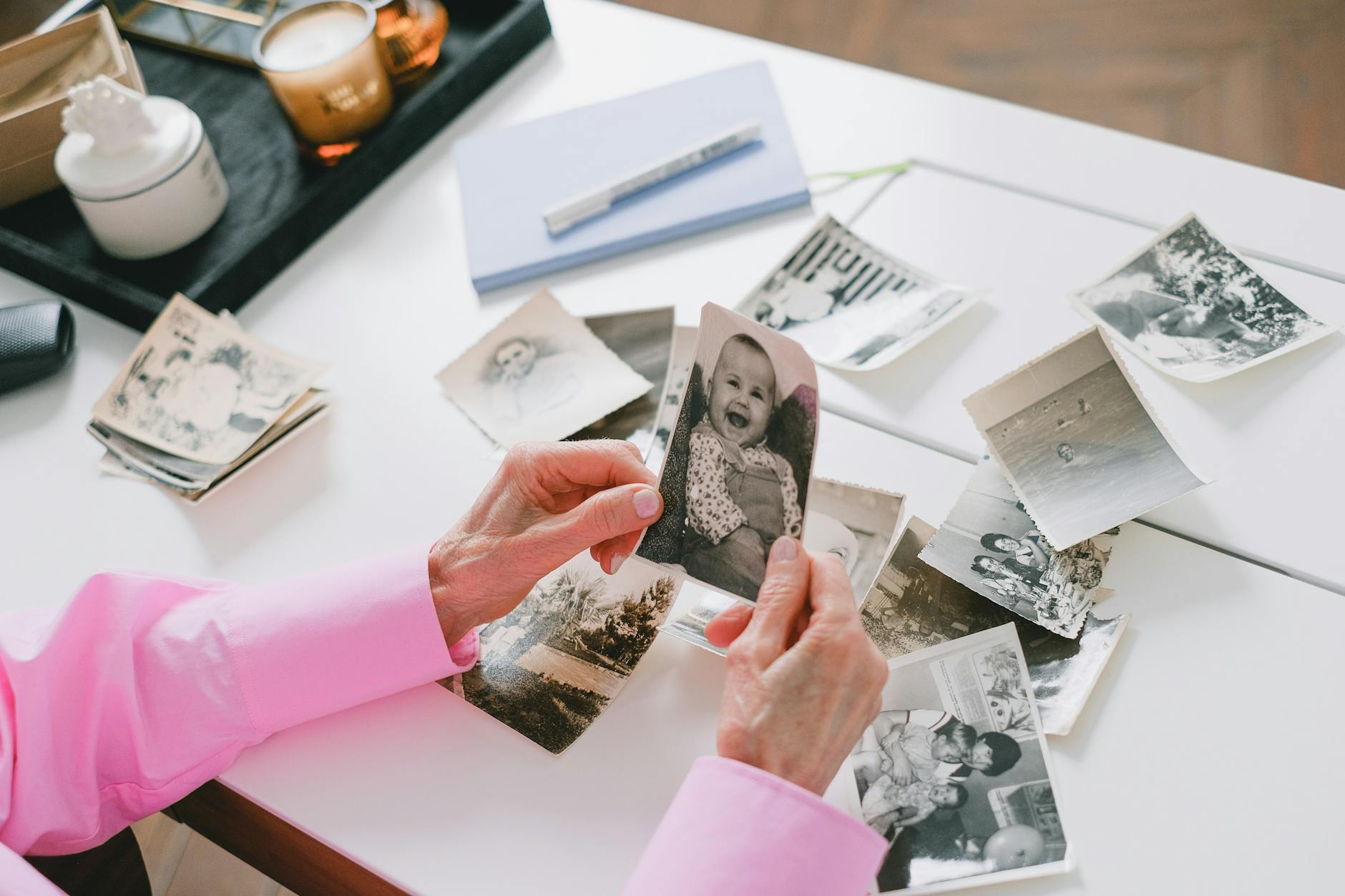 person holding old photos
